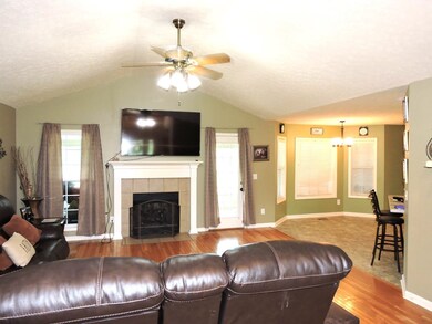 Living room with access to the sunroom and kitchen.
