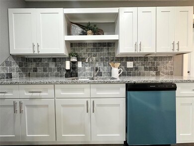 Kitchen with dishwasher and white cabinets