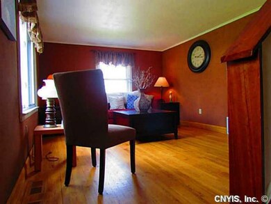 Living Room. Gleaming hardwoods great you as you e