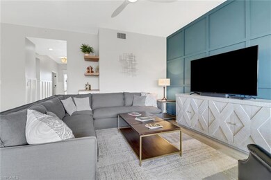 Living room with ceiling fan and light hardwood / 