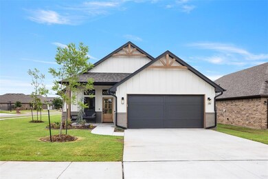 Modern farmhouse style home featuring an attached garage, a front yard, roof with shingles, concrete driveway, and board and batten siding