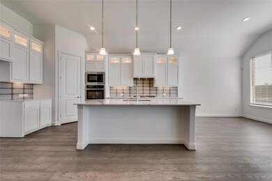 Kitchen with lofted ceiling, stainless steel appli