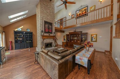 The vaulted great room features a double sided fir