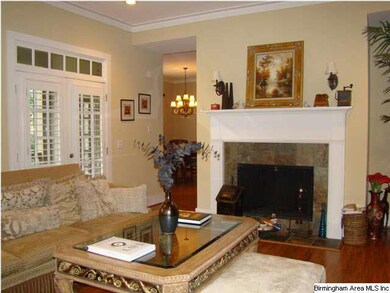 The open floor plan looks past the fireplace into 