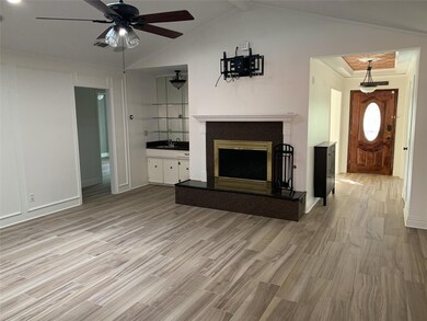Living room with fireplace & wet bar.