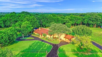 Lush lawns and mature trees surround this amazing property.