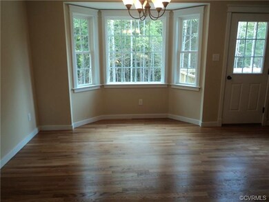 Dining area off kitchen, hardwood floor bay window