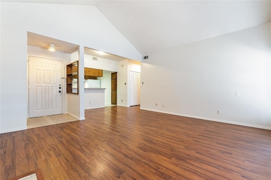 Unfurnished living room with high vaulted ceiling 