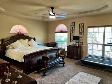 Bedroom featuring carpet, baseboards, ceiling fan,