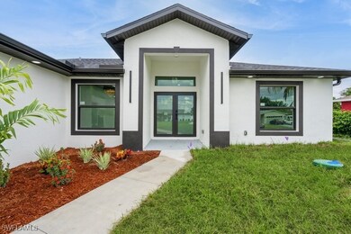 Property entrance featuring stucco siding, a yard,