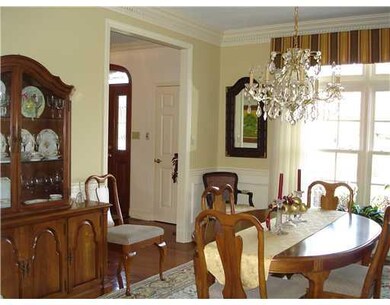 Dining Room. You will appreciate the masterful detailing in the extra deep crown molding and wainscoting of the DR and the supersized window.