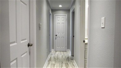 Hallway to bedrooms and bath has new flooring, pai