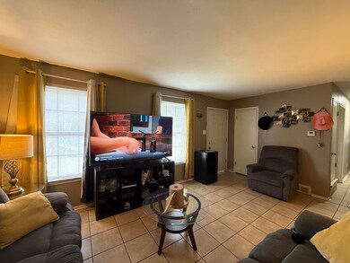 Living room featuring tile patterned floors and plenty of natural light