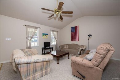 Spacious living room with cathedral ceiling.