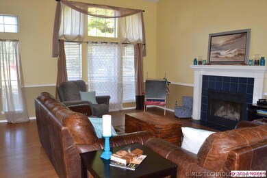 Living room boasts high ceilings,ceiling fan, tran