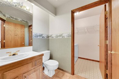 Bathroom with vanity, tasteful backsplash, toilet,