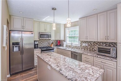 The kitchen features granite countertops, soft-clo