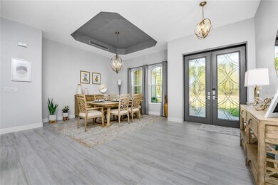 Front doors adorned with beveled glass allow abund
