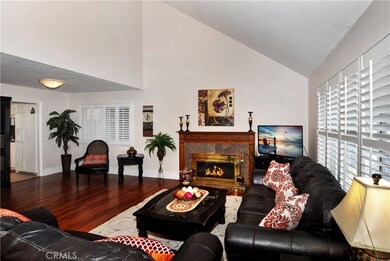 Elegant Formal Living Room with Vaulted Soaring Ceiling, Marble Fireplace, Dual Pane Windows, Plantation Shutters