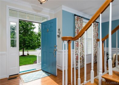 The foyer has hardwood flooring, front door with t