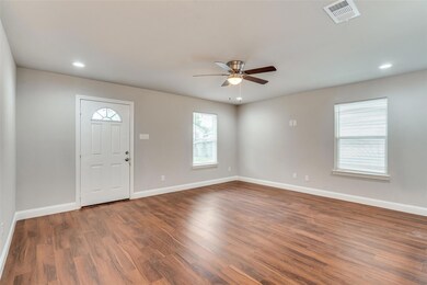 Foyer entrance with visible vents, baseboards, and