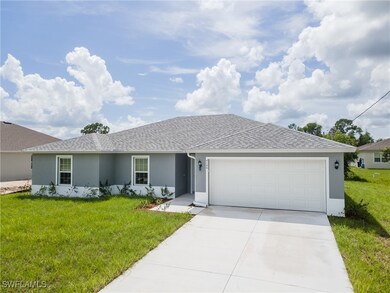 Single story home with a front yard and a garage