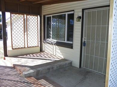 Covered front patio and entry door