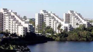 VIEW OF THREE ENCLAVE BUILDINGS FROM LAKE