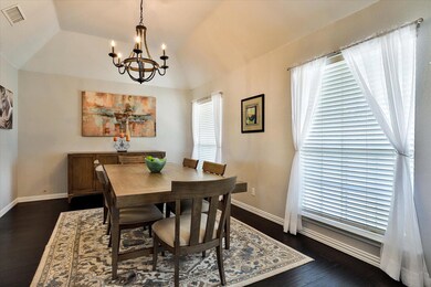 Dining area with vaulted ceiling, dark wood-type f