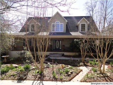 Front of home with beautiful landscaping.