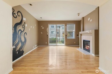 The living space boasts hardwood floors and a gas fireplace.