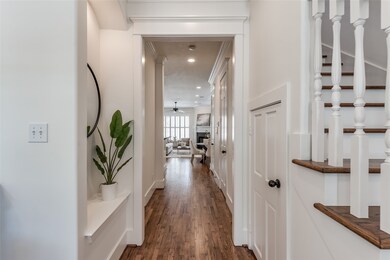 The wide hallway leading to the kitchen and main l