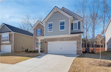 Craftsman-style house featuring cooling unit and a garage