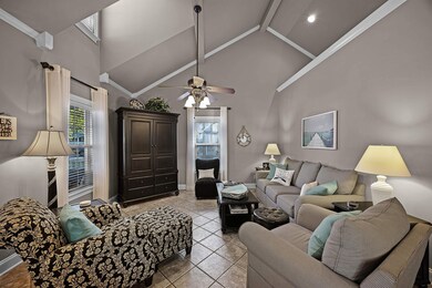 Living room featuring ceiling fan, a wealth of nat