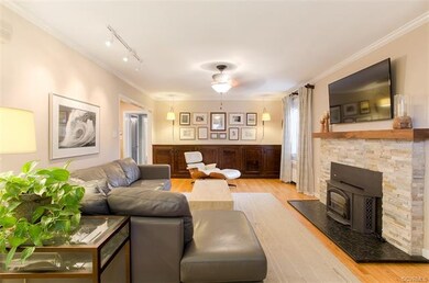Stacked stone fireplace wood burning with woodstove.  Solid walnut mantle.