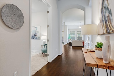 Corridor featuring arched walkways and dark wood-