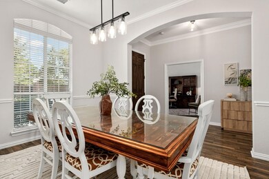 Dining space featuring crown molding and dark hardwood / wood-style floors