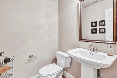 Powder room is conveniently located off the entry 