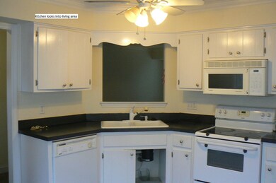 Kitchen looks into living area