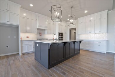 Kitchen featuring white cabinets, a center island 