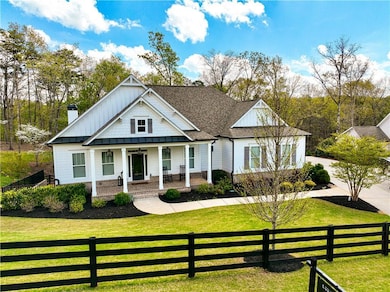 Modern farmhouse style home featuring a chimney, b