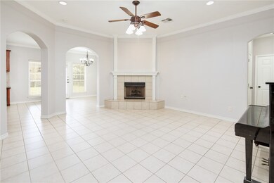 Unfurnished living room with ceiling fan, ornament