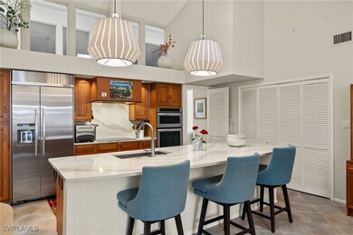 Kitchen with stainless steel appliances, brown cab