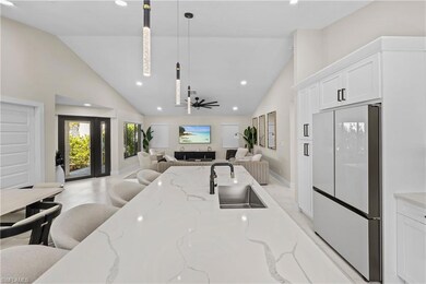 Kitchen featuring white refrigerator, ceiling fan,