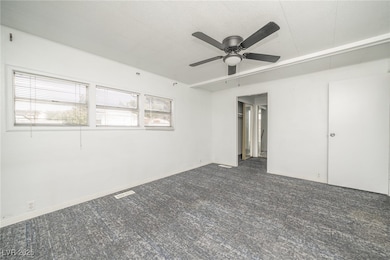 Empty room featuring carpet flooring and a ceiling