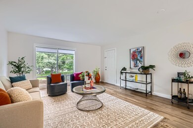 Living room featuring wood finished floors and ba