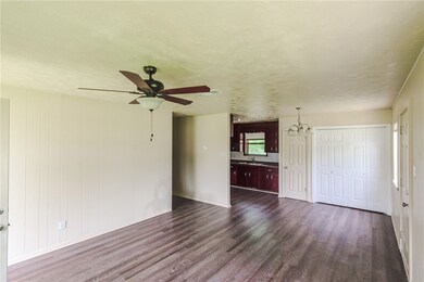 Unfurnished living room featuring dark wood finish