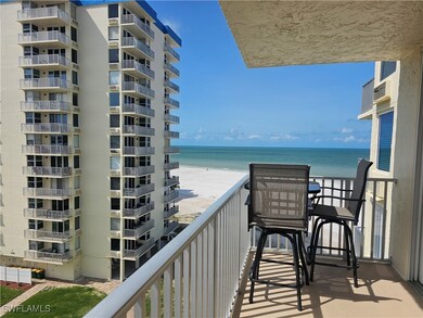 Balcony featuring view of water and beach