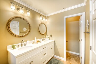 Bathroom with ornamental molding and vanity