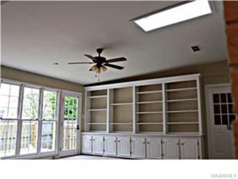 Large additional living area with brick wall and c